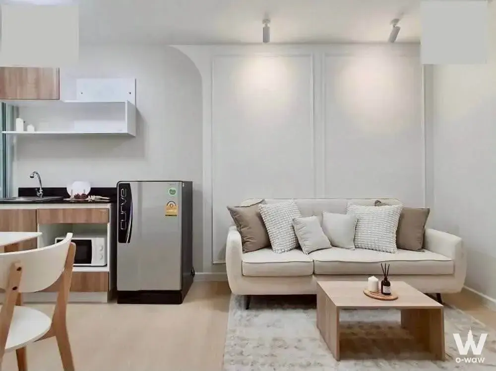 Cream sofa and compact kitchenette in this 1-bed Smart Condo @ Rama 2 rental