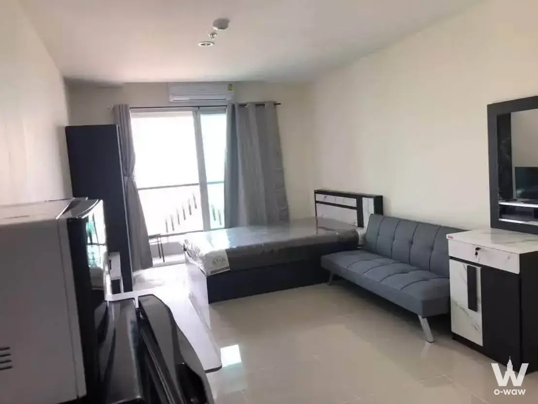 Furnished studio at ASAKAN Place Srinagarindra featuring a queen bed, grey sofa and marble cabinet