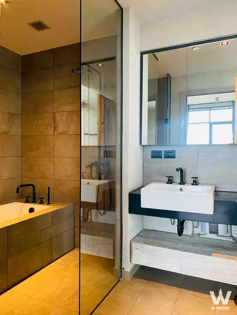 Luxury bathroom with dual vessel sinks and walk-in shower in a 2-bed condo for rent at The Lofts Asoke