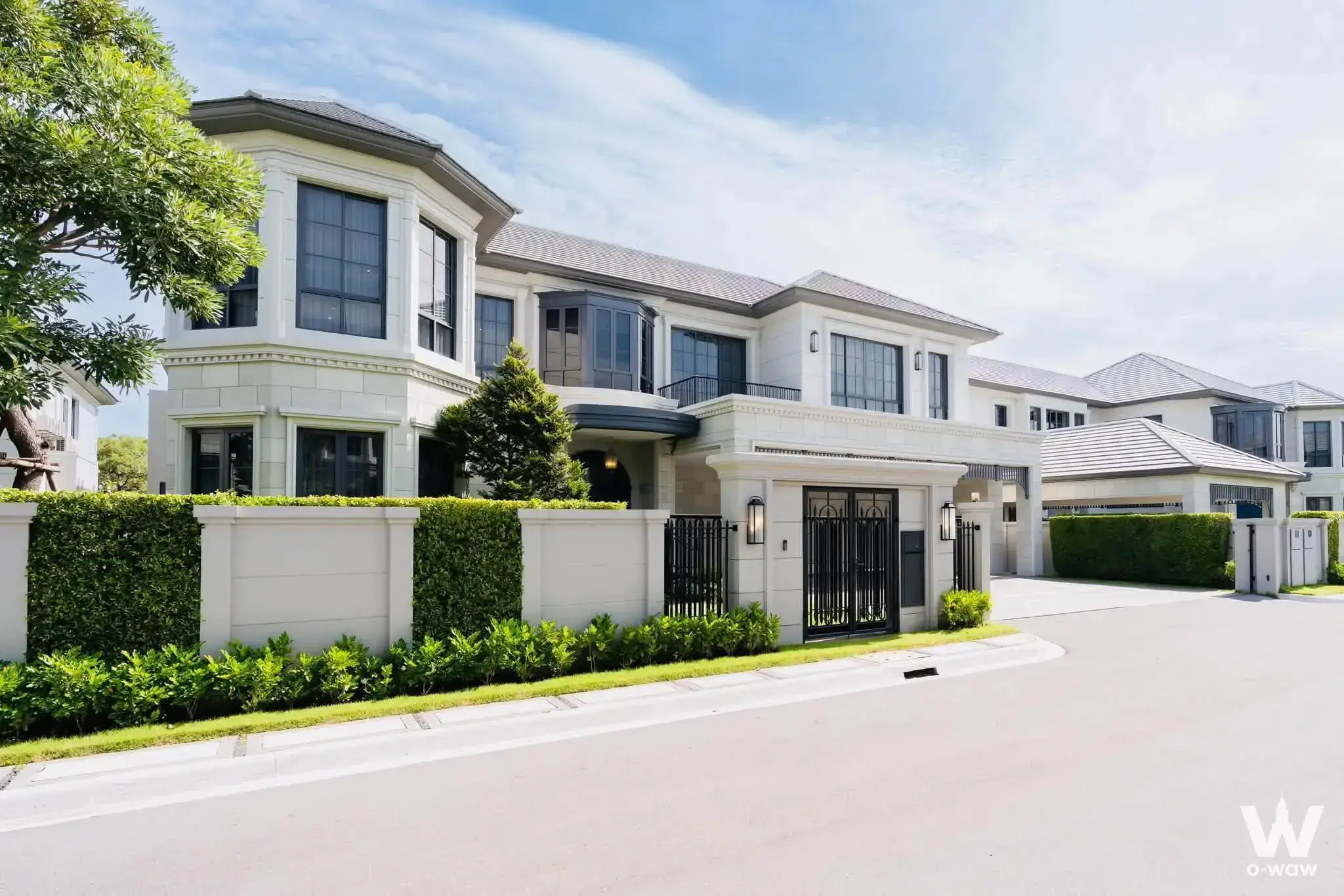 Two-story 4-bed house exterior features a grey roof, black gate and tinted windows in Narasiri Krungthep Kreetha