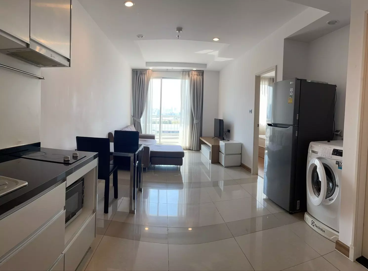 Open-plan living and kitchen area in a Supalai Wellington 1-bed rental with city views