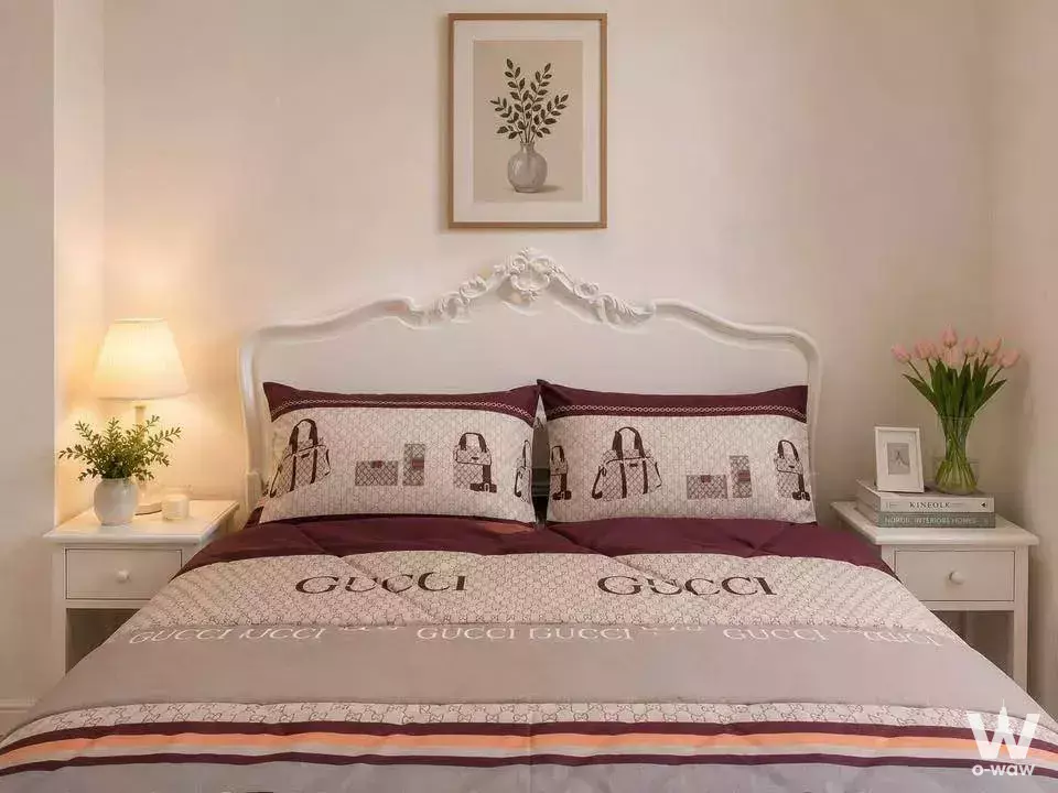 Queen bed with ornate headboard and striped duvet in a European-style bedroom of a 1-bed condo at Ideo Mobi Rama 9