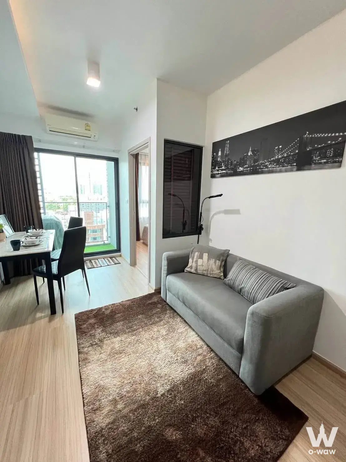 Modern dining-living room with marble table and sofa view in Ideo Sukhumvit 93