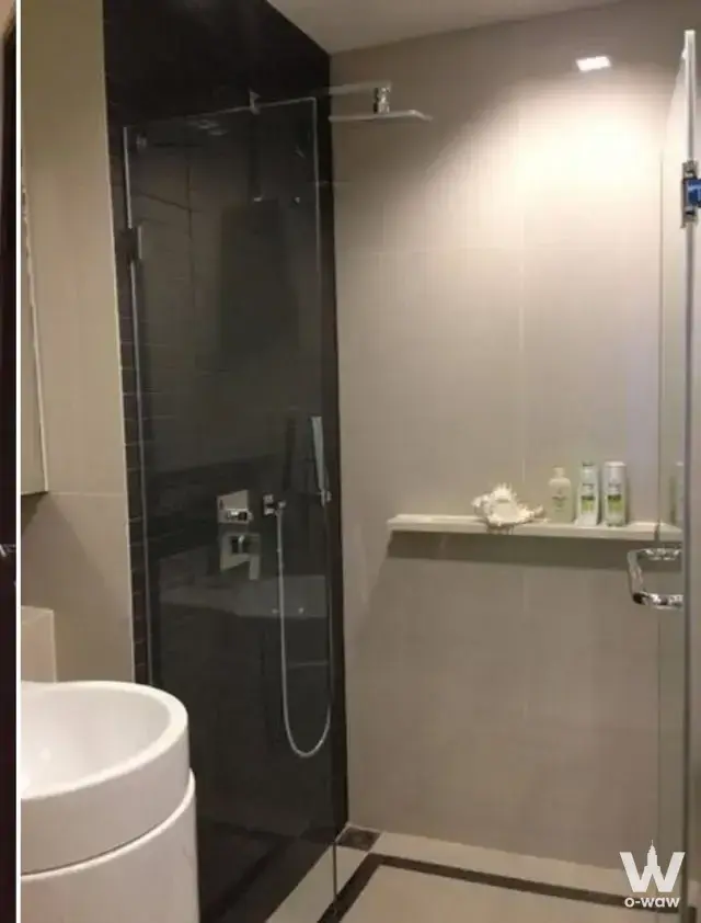 Modern bathroom in RHYTHM Sathorn featuring a frameless glass shower and vessel sink