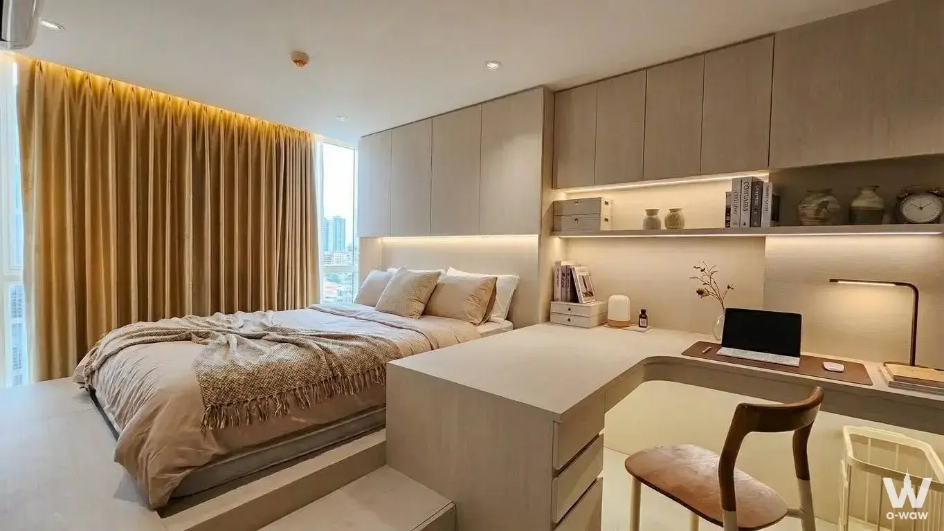 Modern 1-bed condo for sale in Elements Srinagarindra featuring a minimalist bedroom with city skyline view