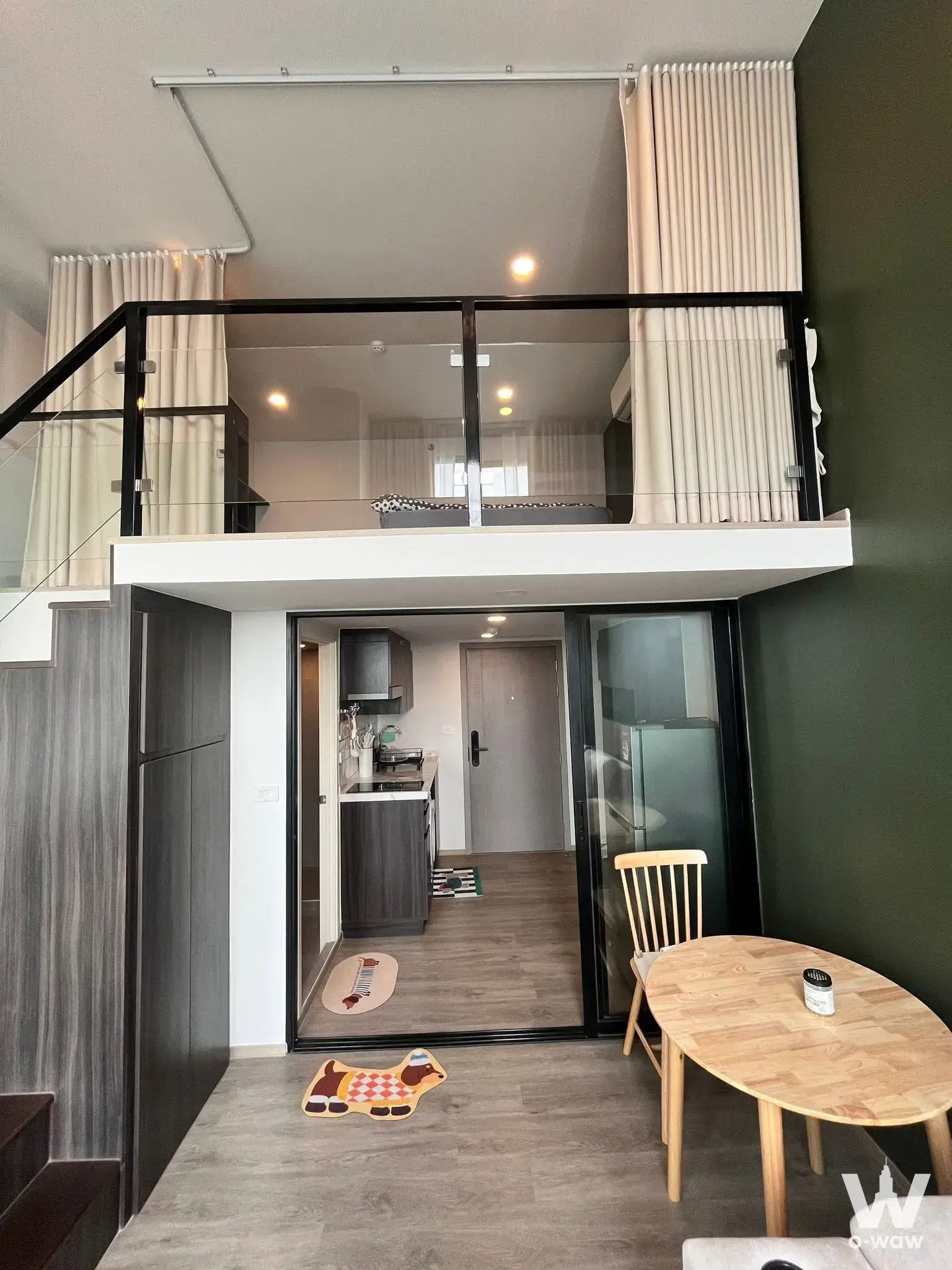 Loft studio with mezzanine bedroom and compact kitchenette in a 1-bed condo for rent at Origin Plug & Play Ramintra