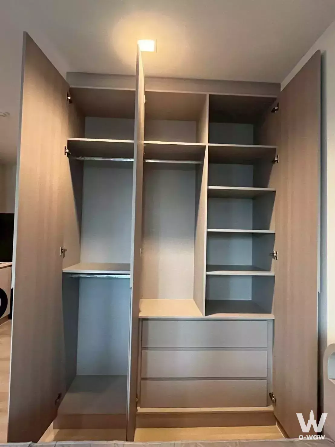 Built-in wardrobe closet in Life One Wireless bedroom with open doors