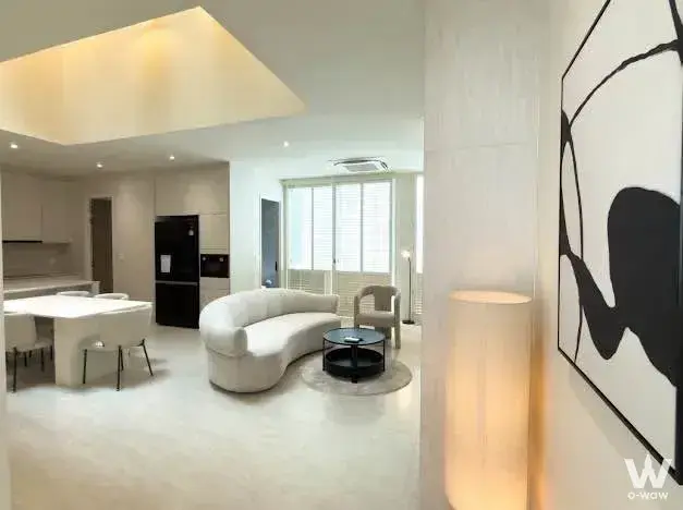 NOBLE TERRA RAMA 9 4-bed condo open-plan living area with modern furniture and warm lighting