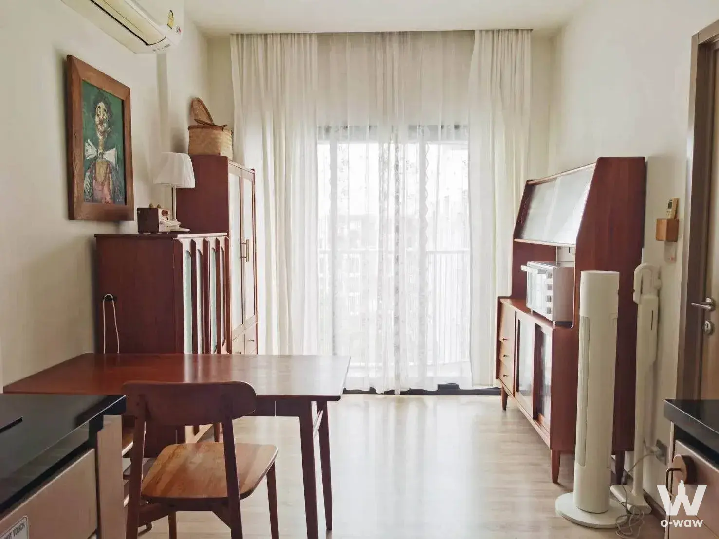 Vintage dining area in Kawa Haus 1-bed condo with dark wood table and mid-century teak console