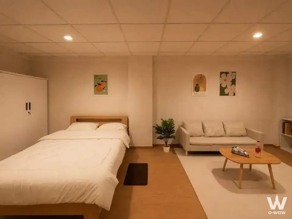 Minimalist Scandinavian bedroom for sale at บ้านฝันคอนโดวิลล์ with light wood furniture, white wardrobe, and botanical art