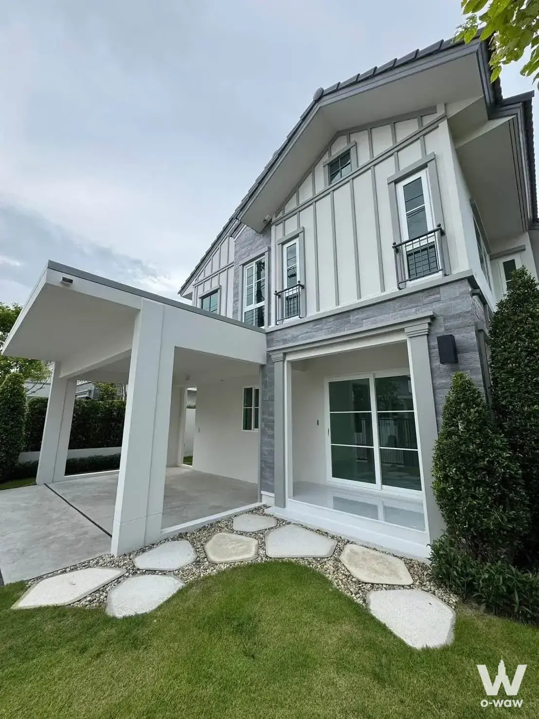 Modern two-story detached house with grey stone cladding at Villaggio 3 Srinakarin-Bangna
