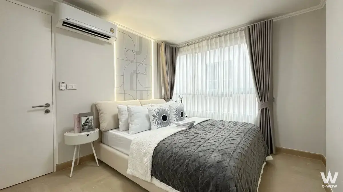 Master bedroom in The Clover Thonglor Residence featuring a queen bed and geometric headboard