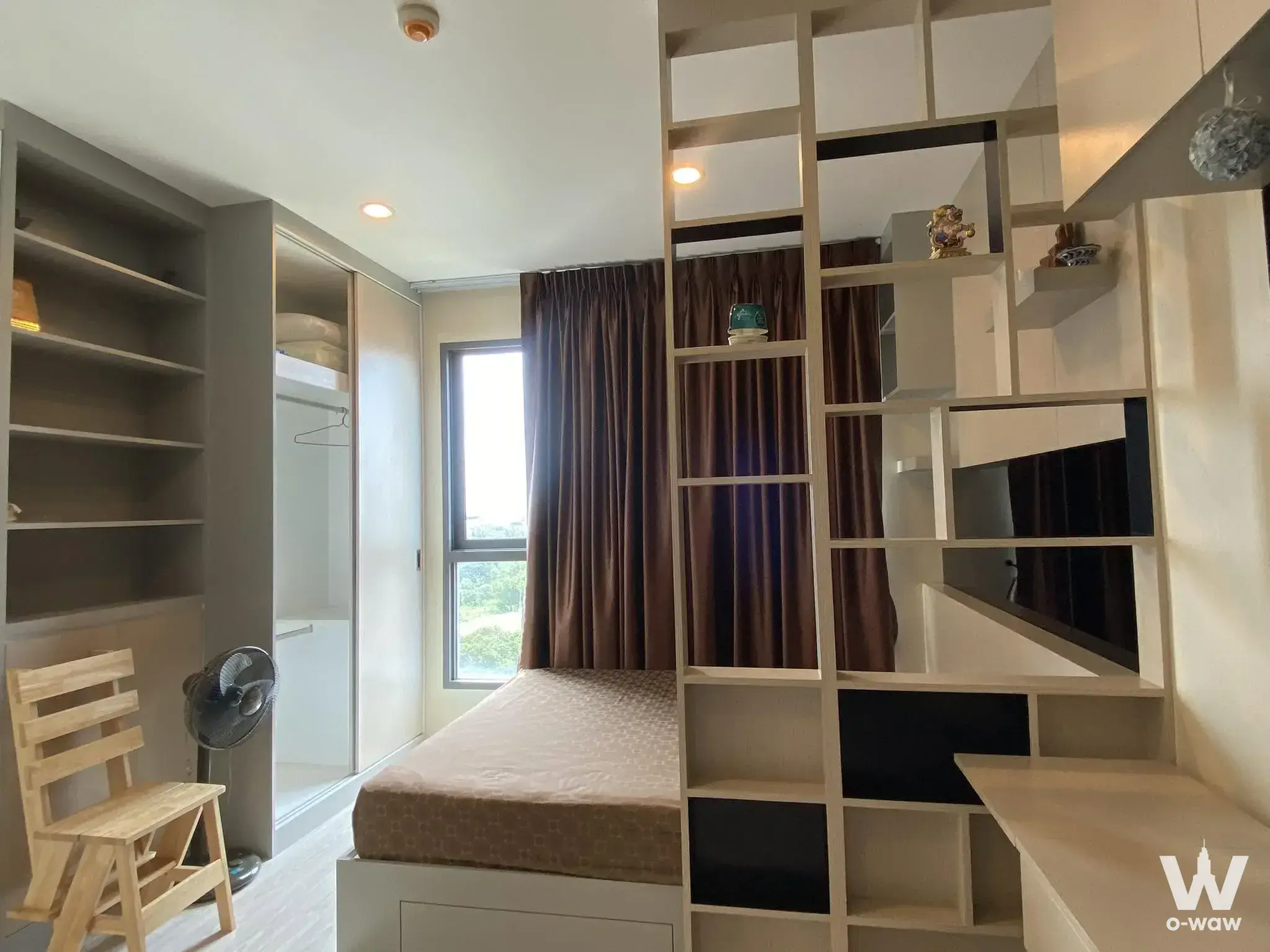 Ideo Mobi Sukhumvit Eastgate 1-bed bedroom with storage bed, wardrobe, and geometric room divider