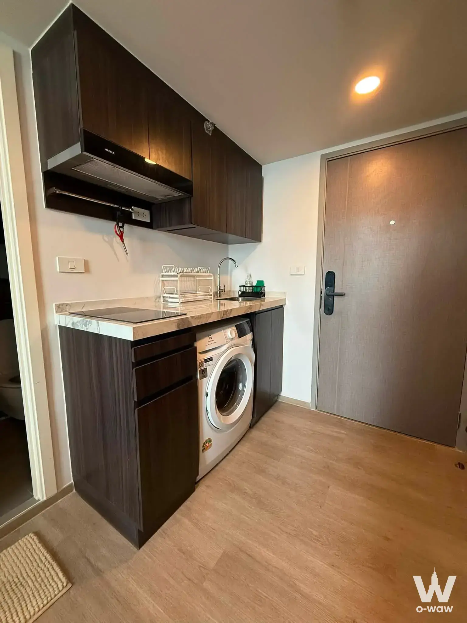 1-bed kitchenette in Origin Plug & Play Ramintra featuring induction cooktop and integrated washing machine