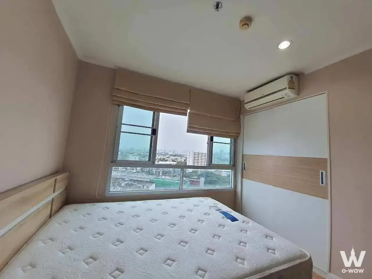 Unfurnished bedroom in Lumpini Ville Ladprao-Chokchai4 with white wardrobe and city view window
