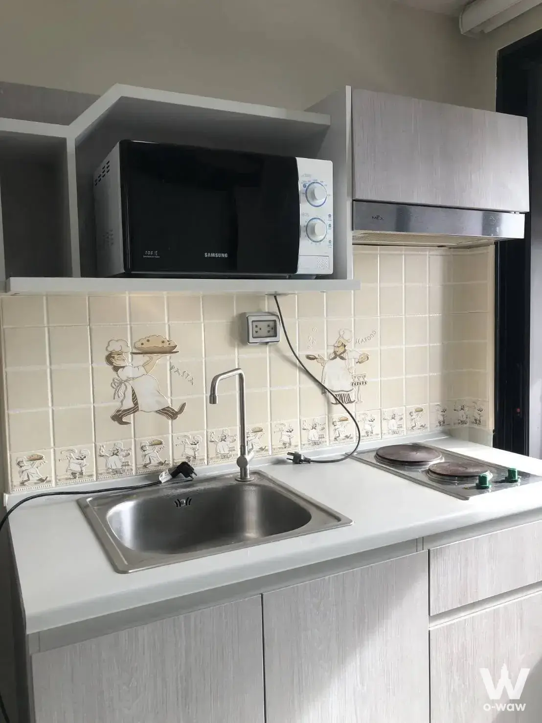 Compact kitchenette in Premio Fresco with two-burner cooktop and sink
