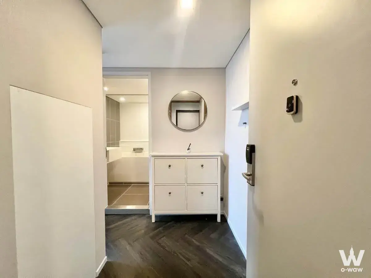 Unfurnished entryway in Siamese Sukhumvit 48 featuring herringbone wood floors and a smart door lock