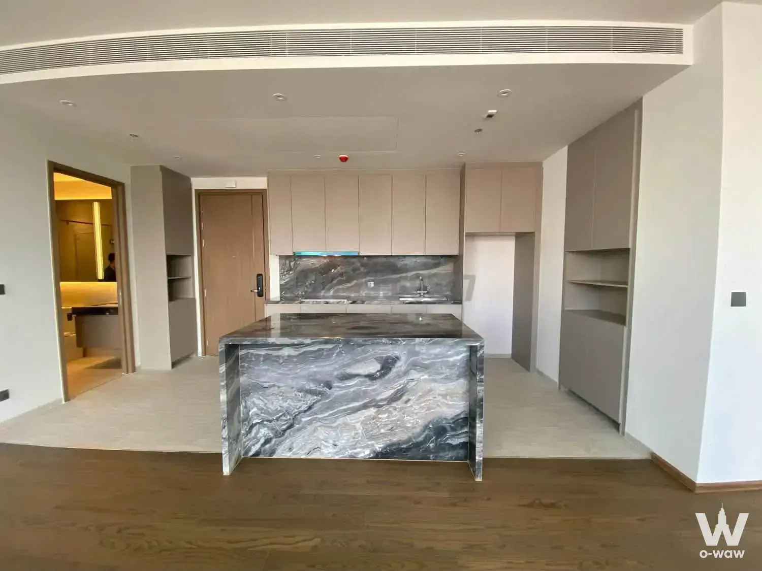 2-bed condo for sale in Via Ari with open-plan kitchen island, dark marble backsplash, and minimalist design