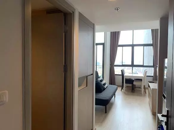 Furnished studio with sofa bed and city view in a 1-bed condo for rent at Ideo New Rama 9