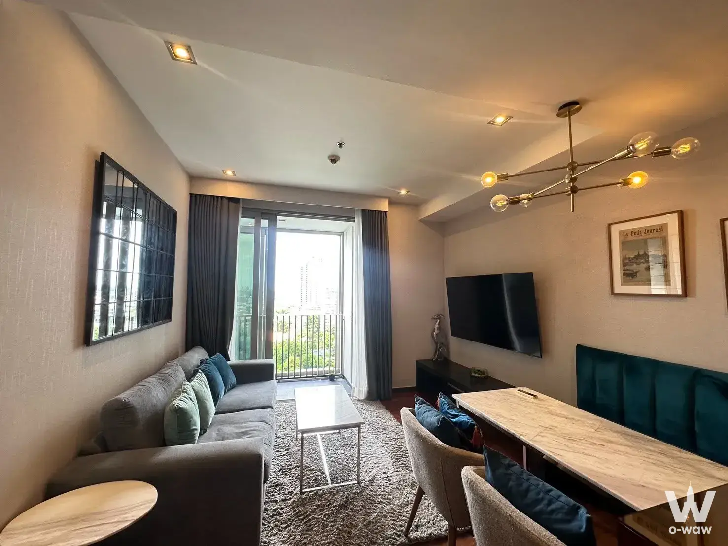 Ashton Morph 38 2-bed condo for rent featuring open-plan living with teal accents and marble dining table
