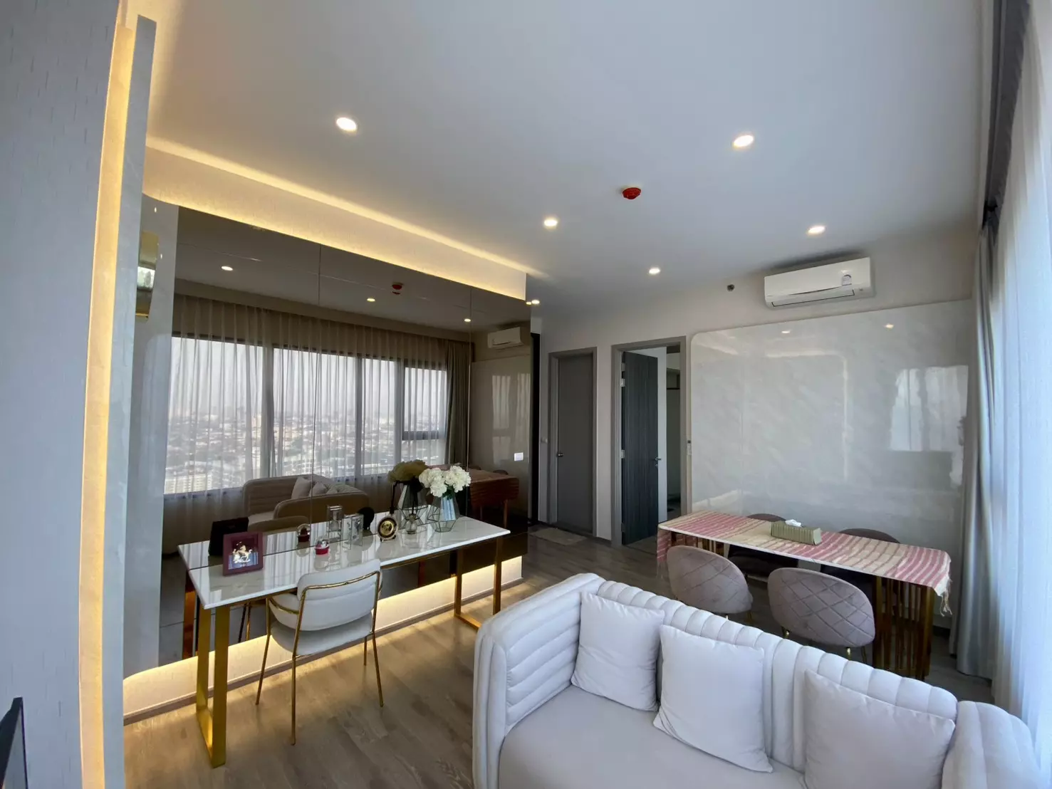 Open-plan living and dining room in a KnightsBridge Prime Onnut 2-bed rental with marble accents and city views