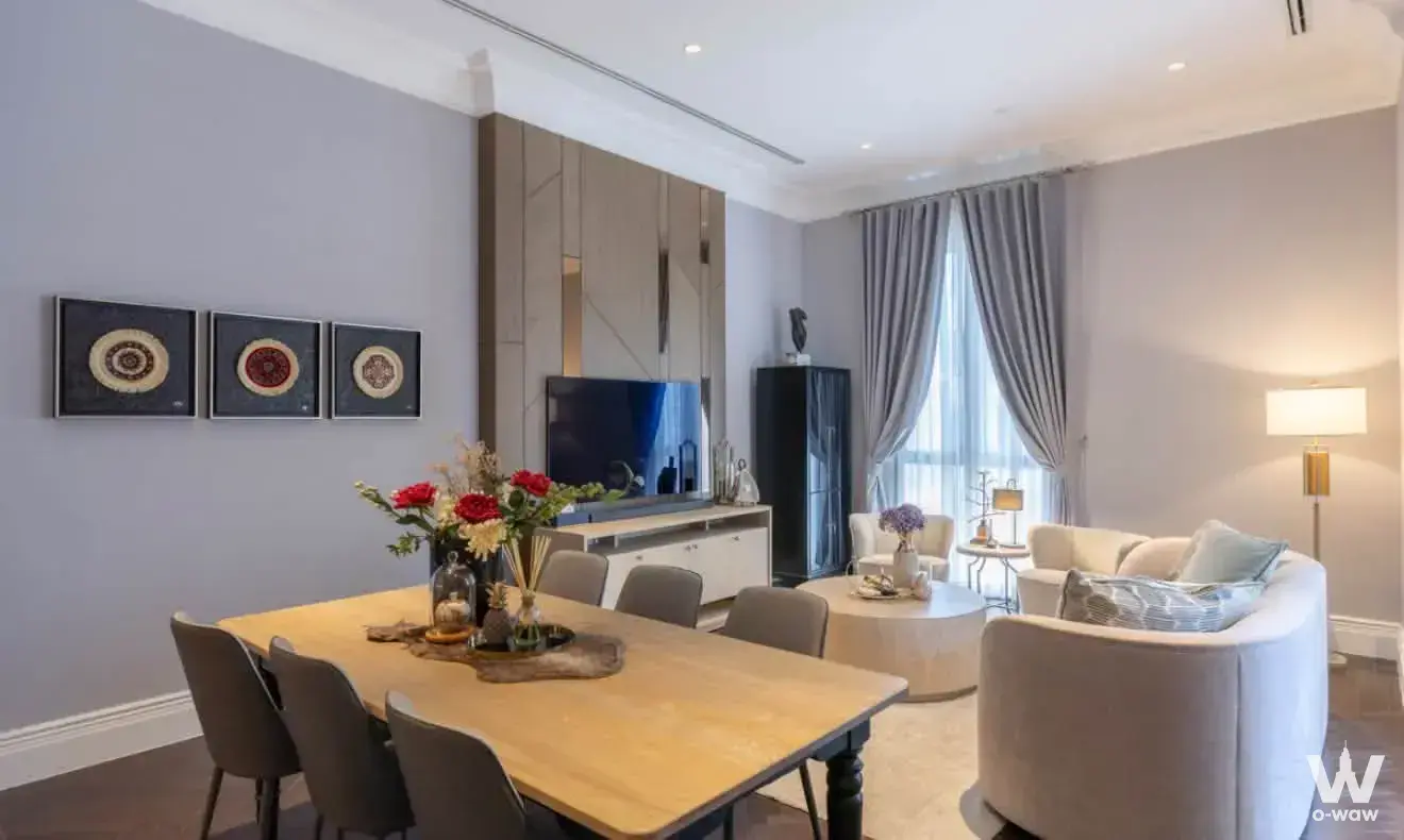 3-bed condo living and dining area in 98 Wireless featuring grey sofa and light wood floors