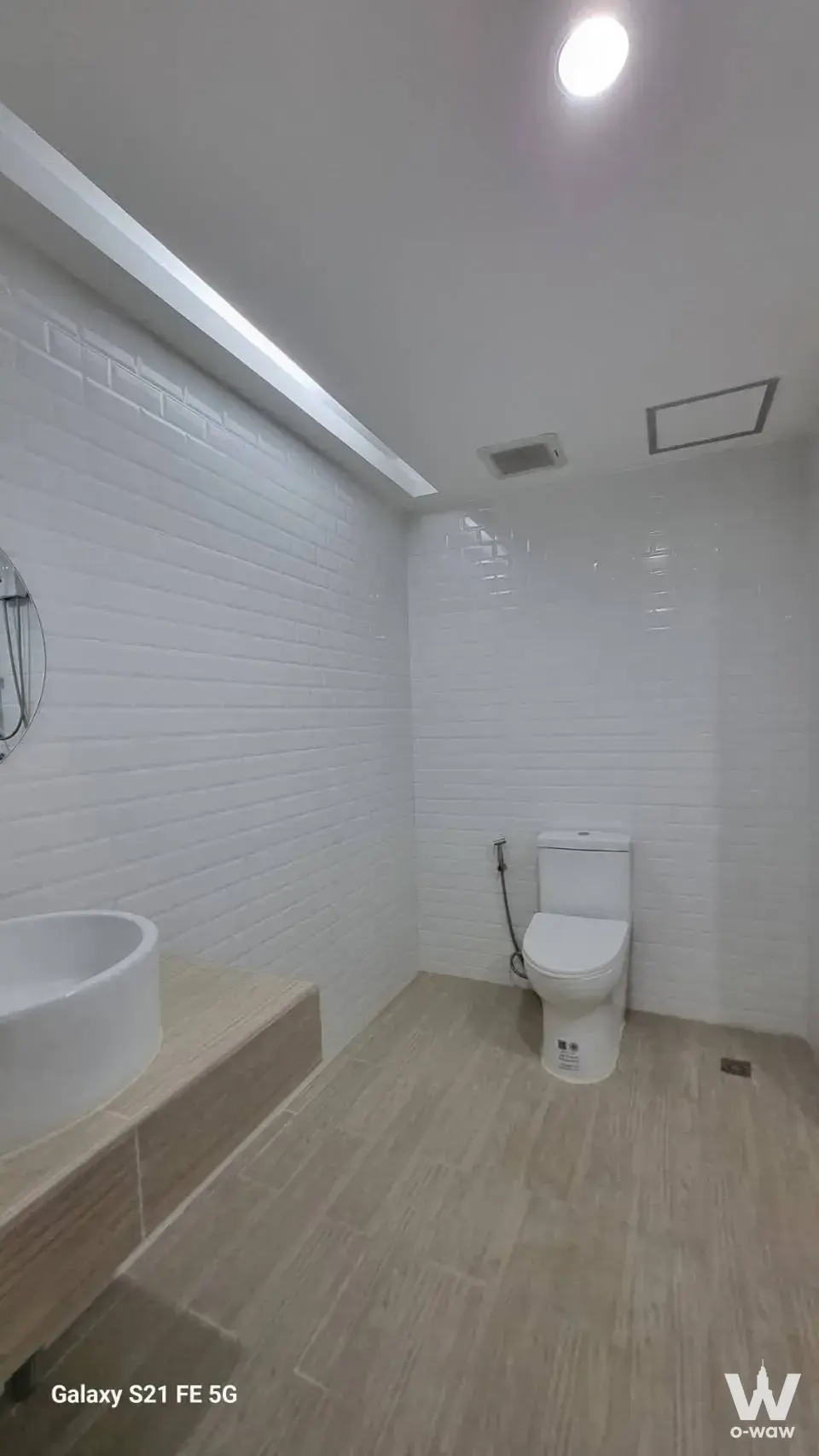 Minimalist 1-bed condo bathroom in The Trio Garden with white subway tiles, vessel sink, and wood-look flooring