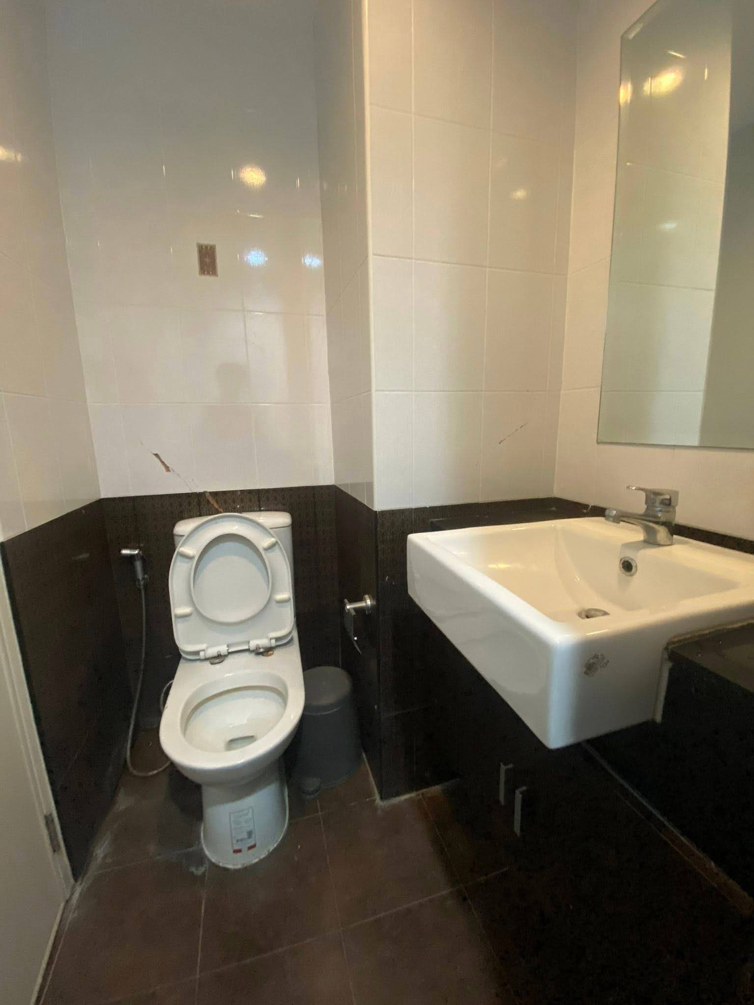 Compact bathroom featuring dark wood vanity and two-tone tiling in ASAKAN Place Srinagarindra 1-bed condo