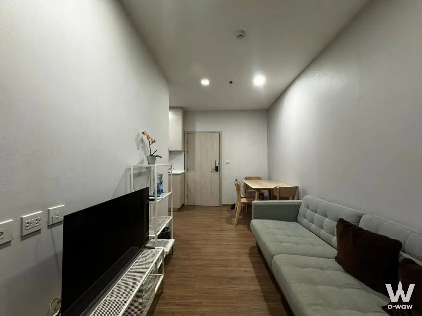 Furnished living room in Metris Rama 9 condo featuring sofa and compact dining area