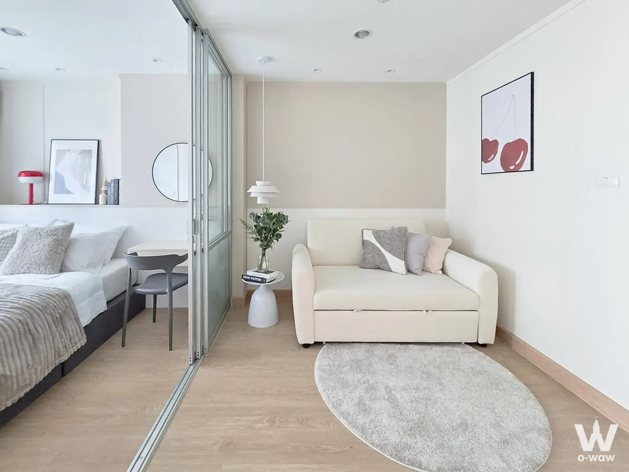 Open-plan studio with cream sofa and sliding partition in a Lumpini Mega City Bang Na 1-bed condo
