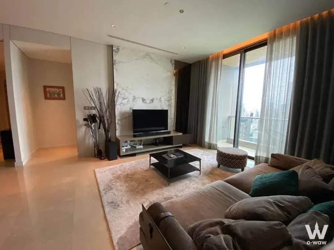 Sindhorn Residence luxury living room with marble feature wall, sectional sofa, and skyline view