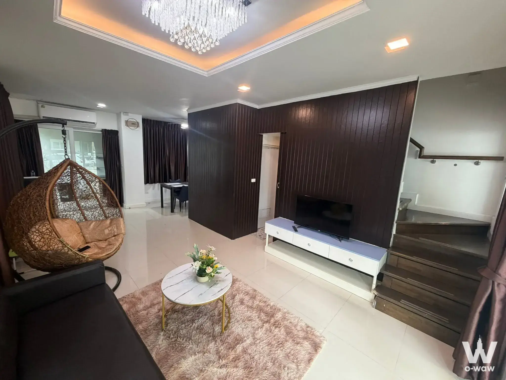 Duplex living room in Bless Town Srinakarin with wood slat wall and marble coffee table