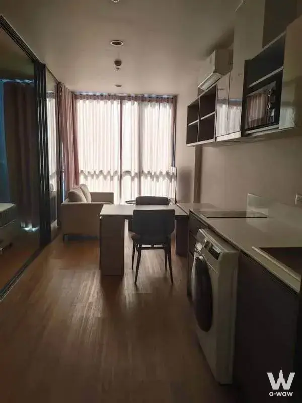 Compact furnished studio for rent at The Issara Sathorn featuring open-plan layout, built-in kitchen, and balcony access