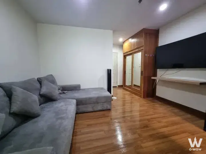 Modern 1-bed condo for sale in Regent Home Bangson 27 featuring a grey sectional sofa and wood plank flooring