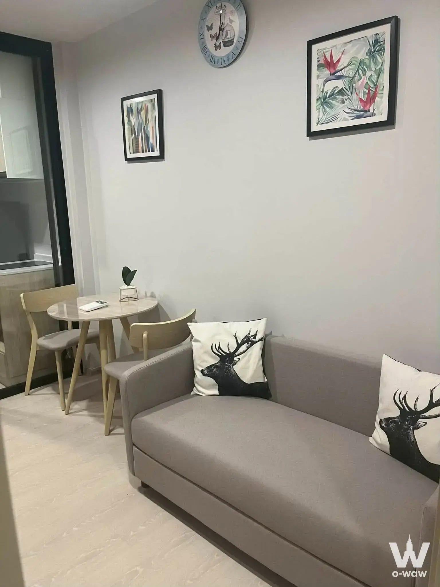 1-bed condo for rent in Nue Mega Plus Bangna with modern living room, stag print pillows, and marble-effect table