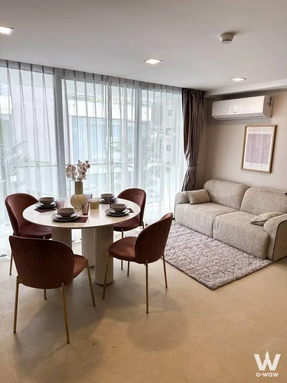 2-bed living area in Aurora Pratumnak with marble dining table and sofa near palm tree view
