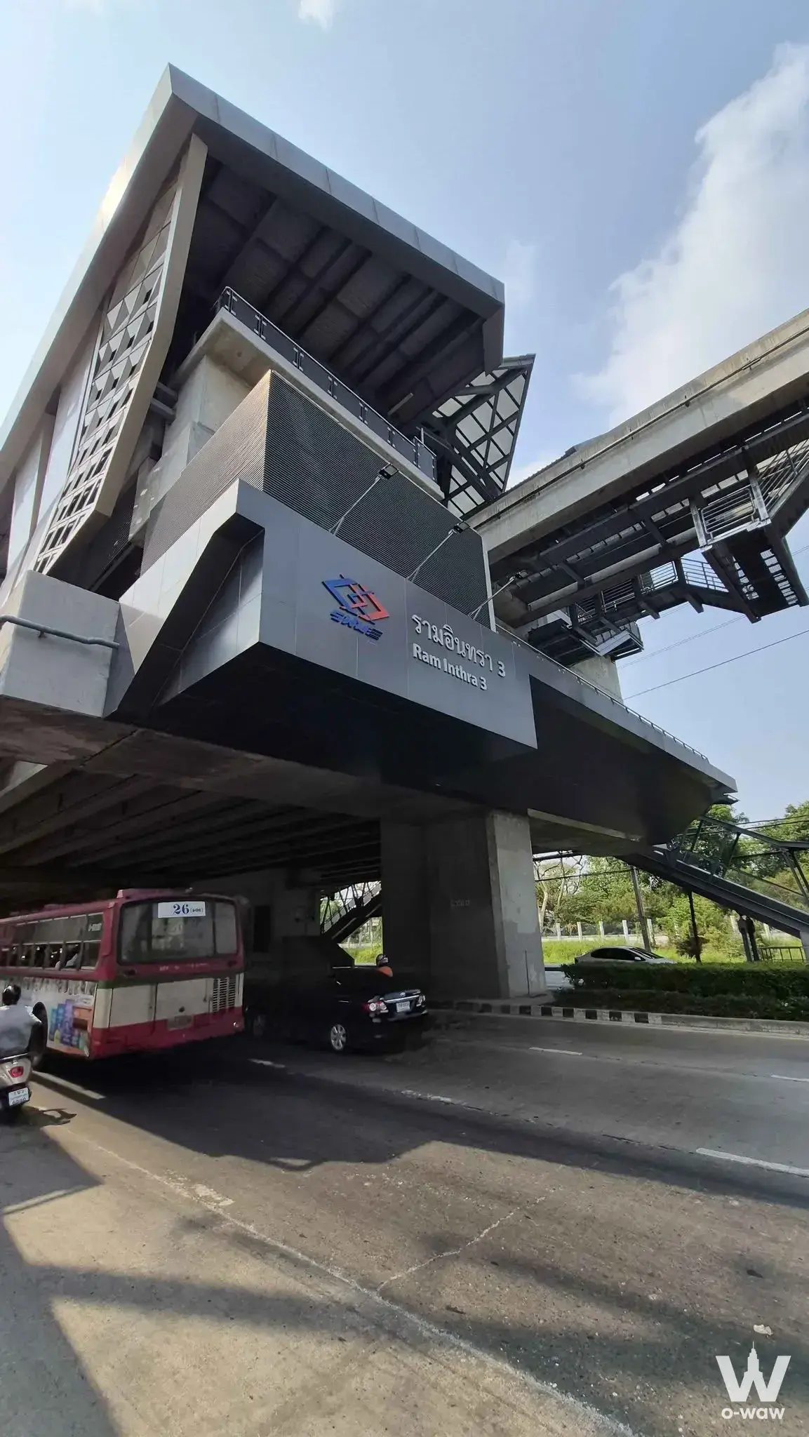 Elevated Ram Inthra 3 Skytrain station with geometric diamond lattice facade and urban traffic