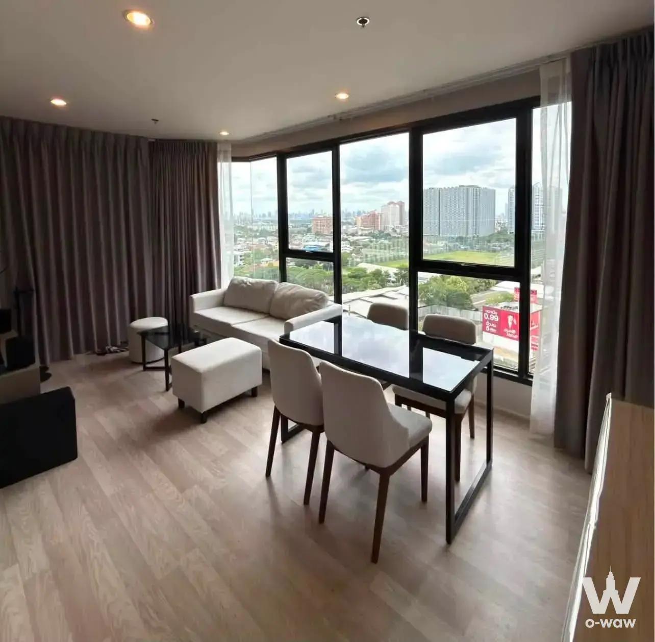 Bright living room with floor-to-ceiling windows and city views in this 2-bed Ideo Mobi Sukhumvit Eastpoint condo