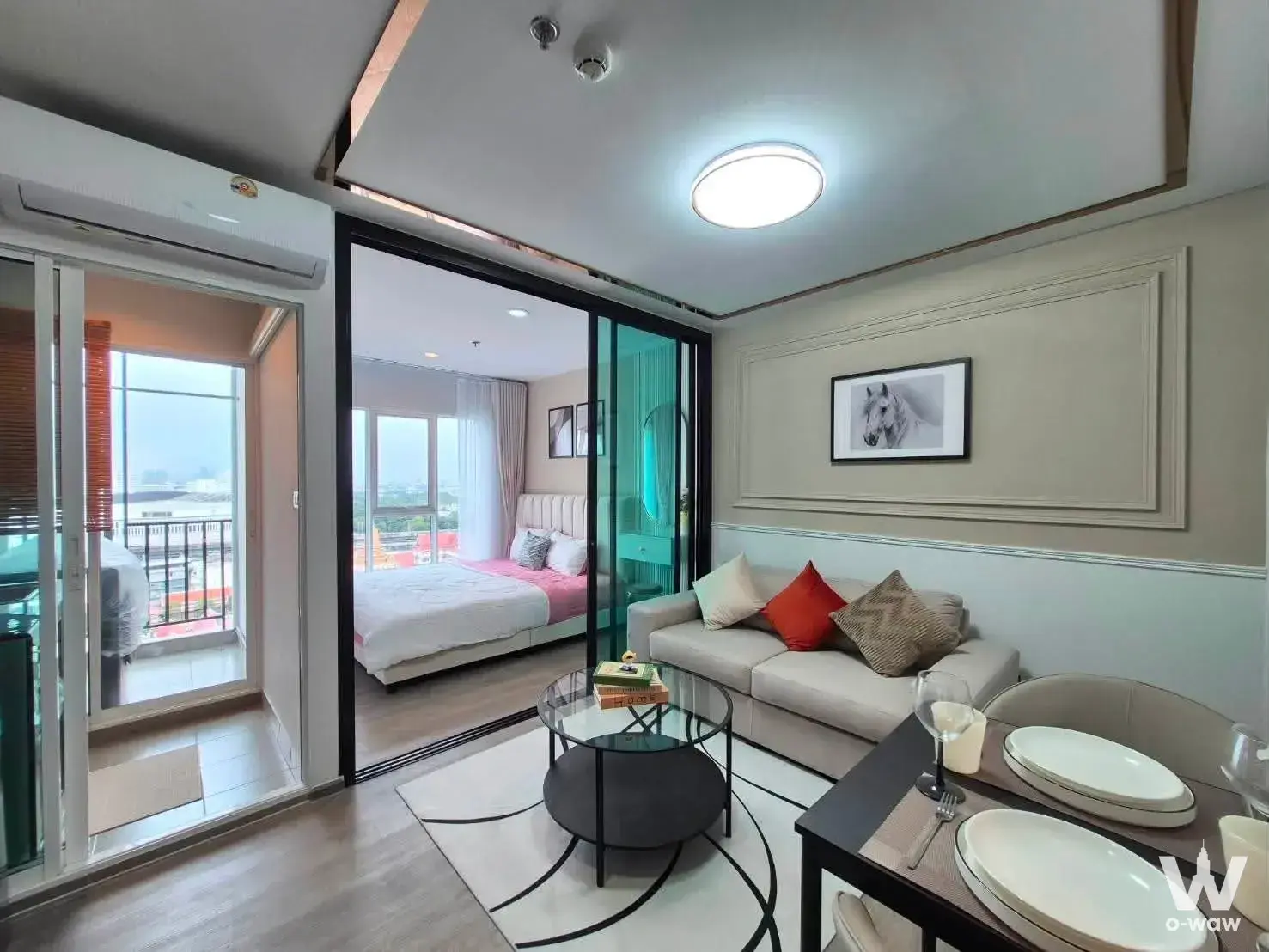 Open-plan living and dining area with city view at Regent Home Bangna condo for rent
