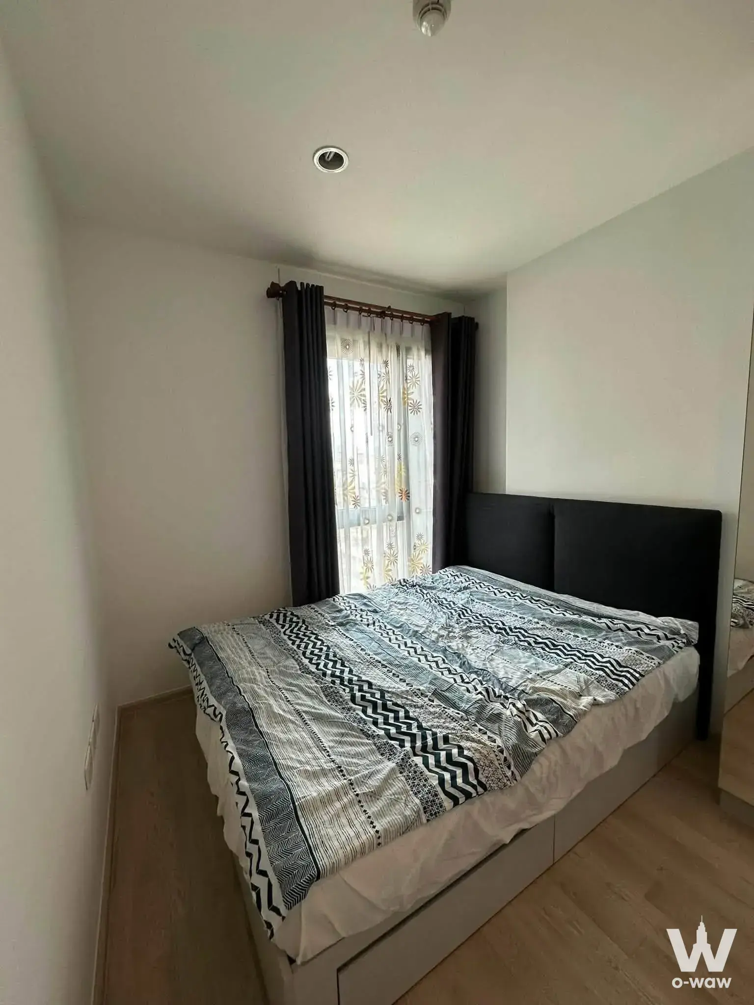 Bedroom in Centric Ratchada-Huai Kwang condo with geometric duvet and sheer embroidered curtains