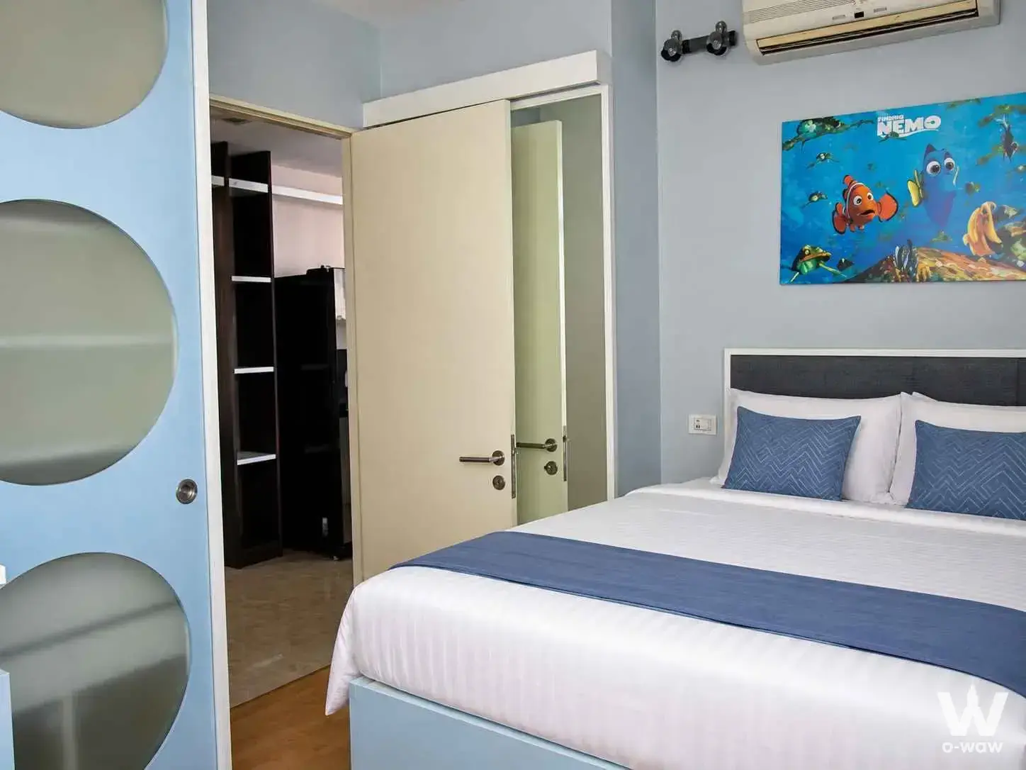 Nusasiri Grand Condo 3-bed bedroom with light blue walls, Finding Nemo poster, and built-in wardrobe