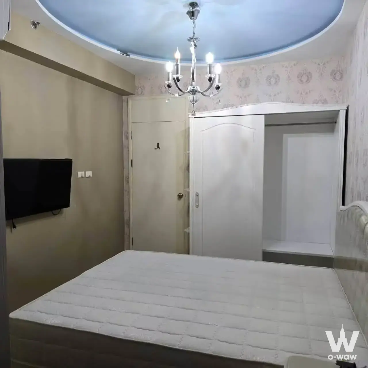 Bedroom in Supalai River Resort condo with queen mattress, chrome chandelier, and blue ceiling mural