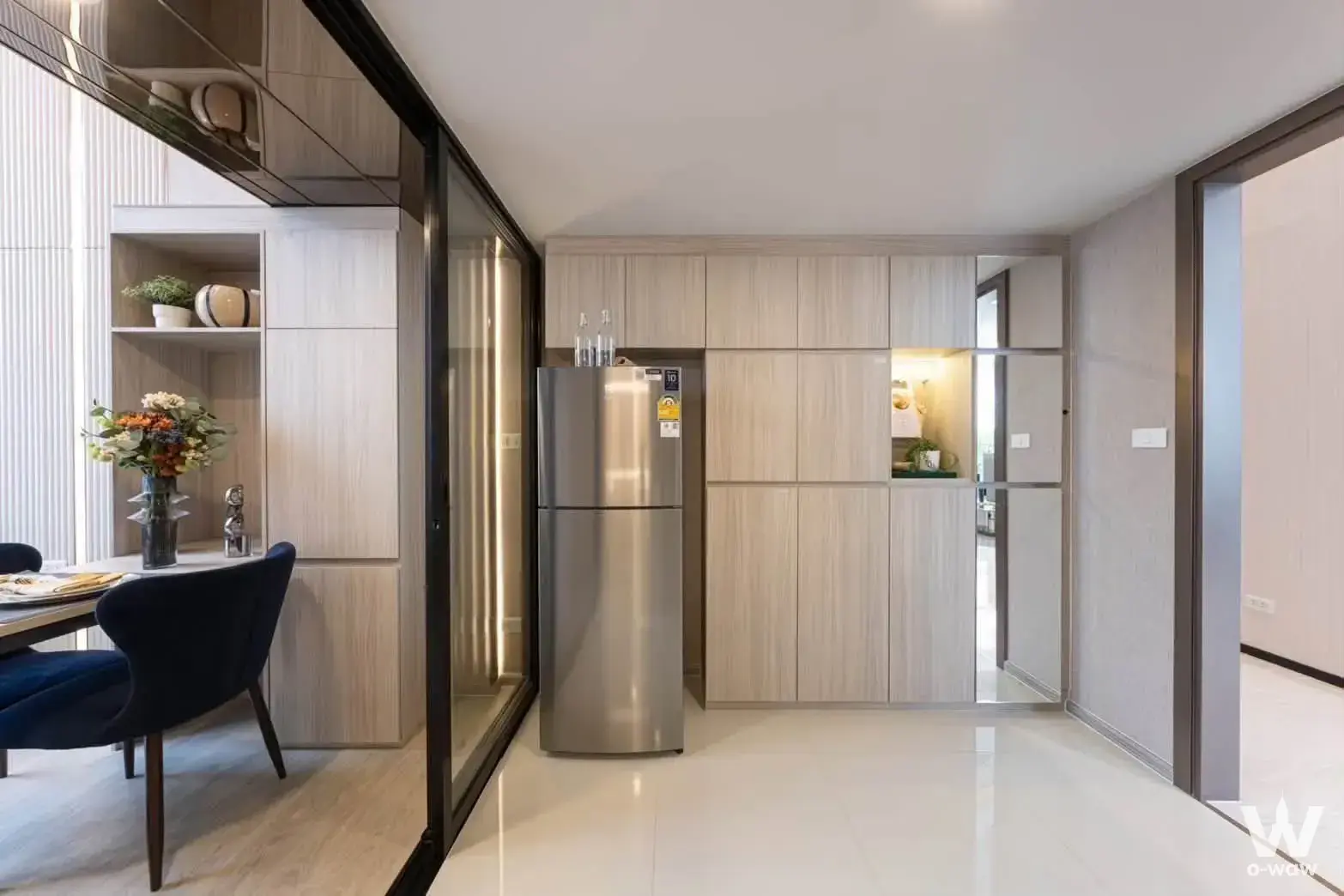 Dining area with wood cabinetry and glass partition in Origin Place Phetkasem condo for sale