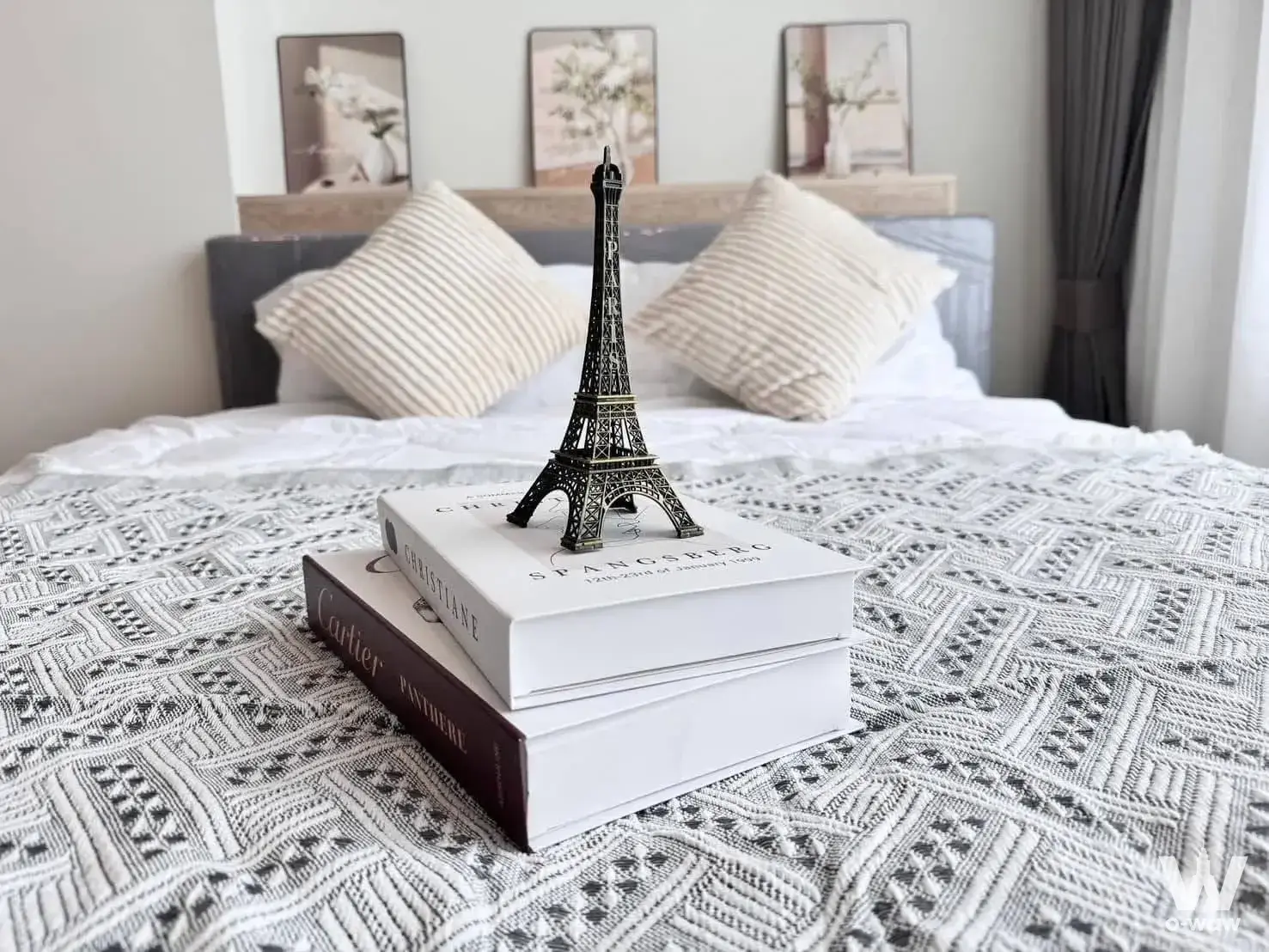 Chewathai Kaset-Nawamin bedroom featuring grey upholstered headboard and botanical wall art