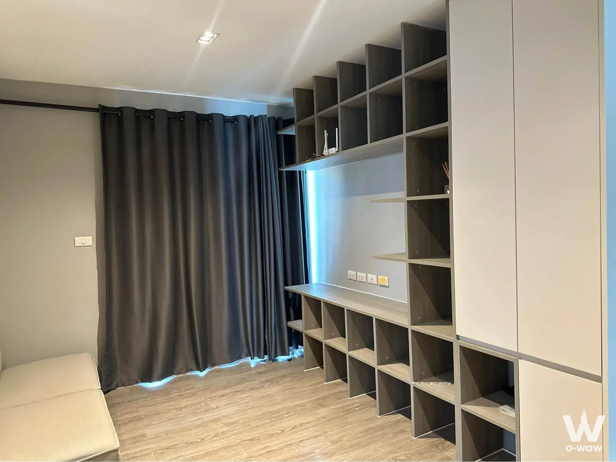 Living room in Aspen Condo Lasalle featuring dark grey shelving and blue LED backlighting
