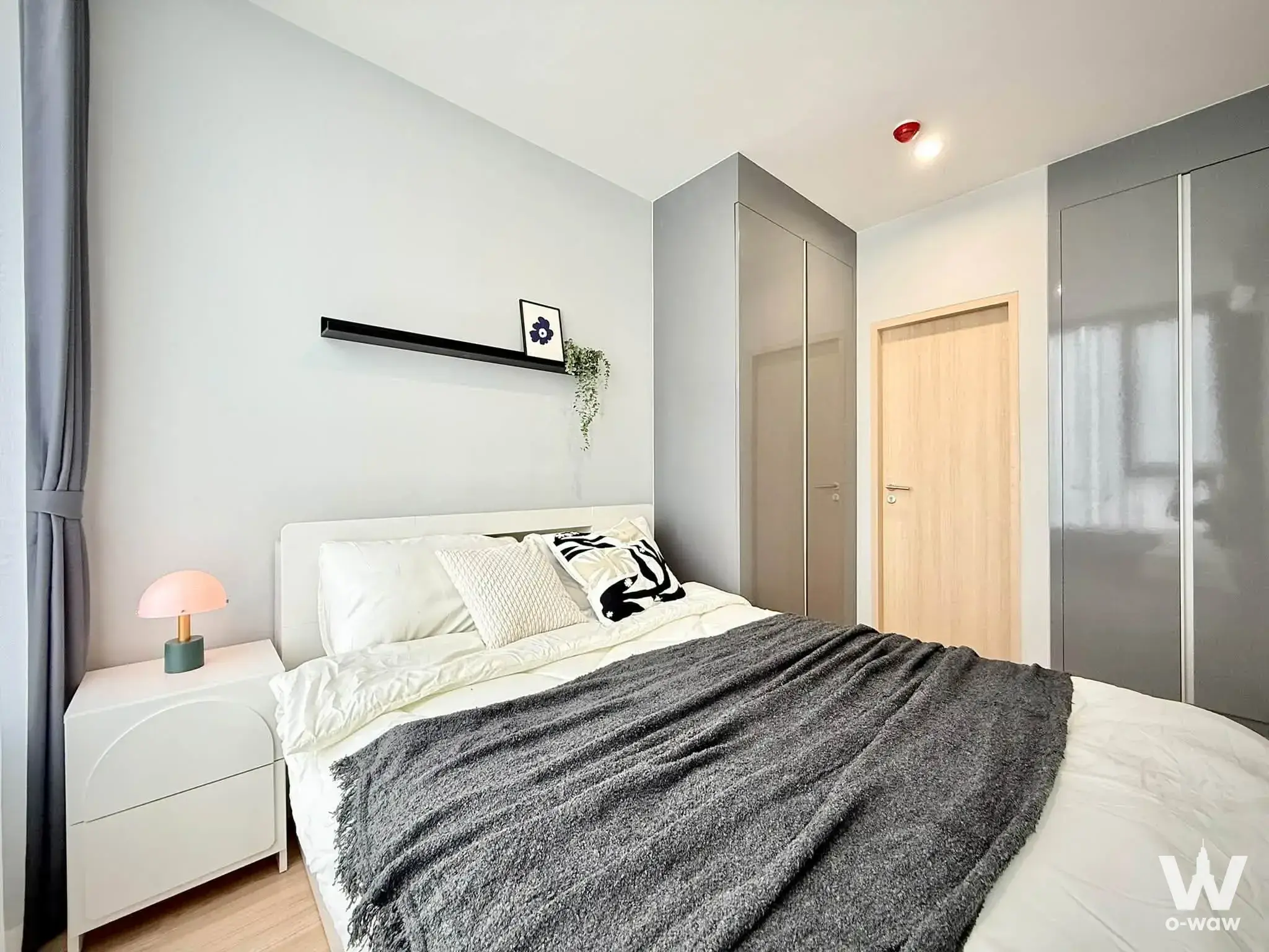 Bedroom in Skyrise Avenue Sukhumvit 64 condo with queen bed and floor-to-ceiling wardrobes