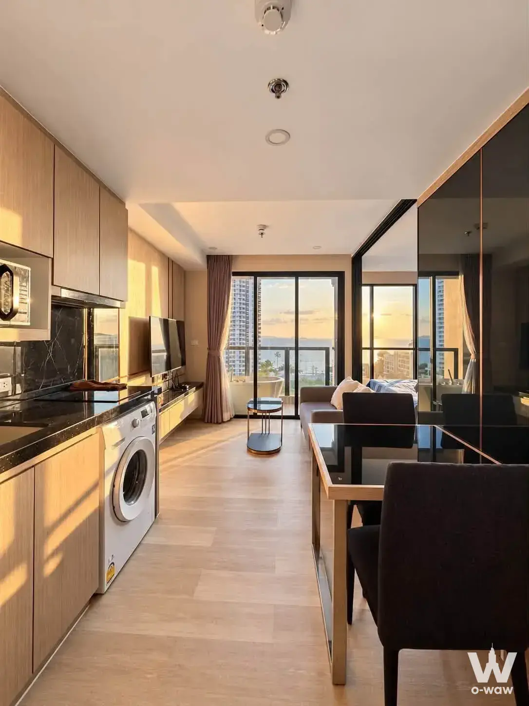 This open-plan studio in a 1-bed condo for rent at The Panora Pattaya has a bathtub and ocean sunset view