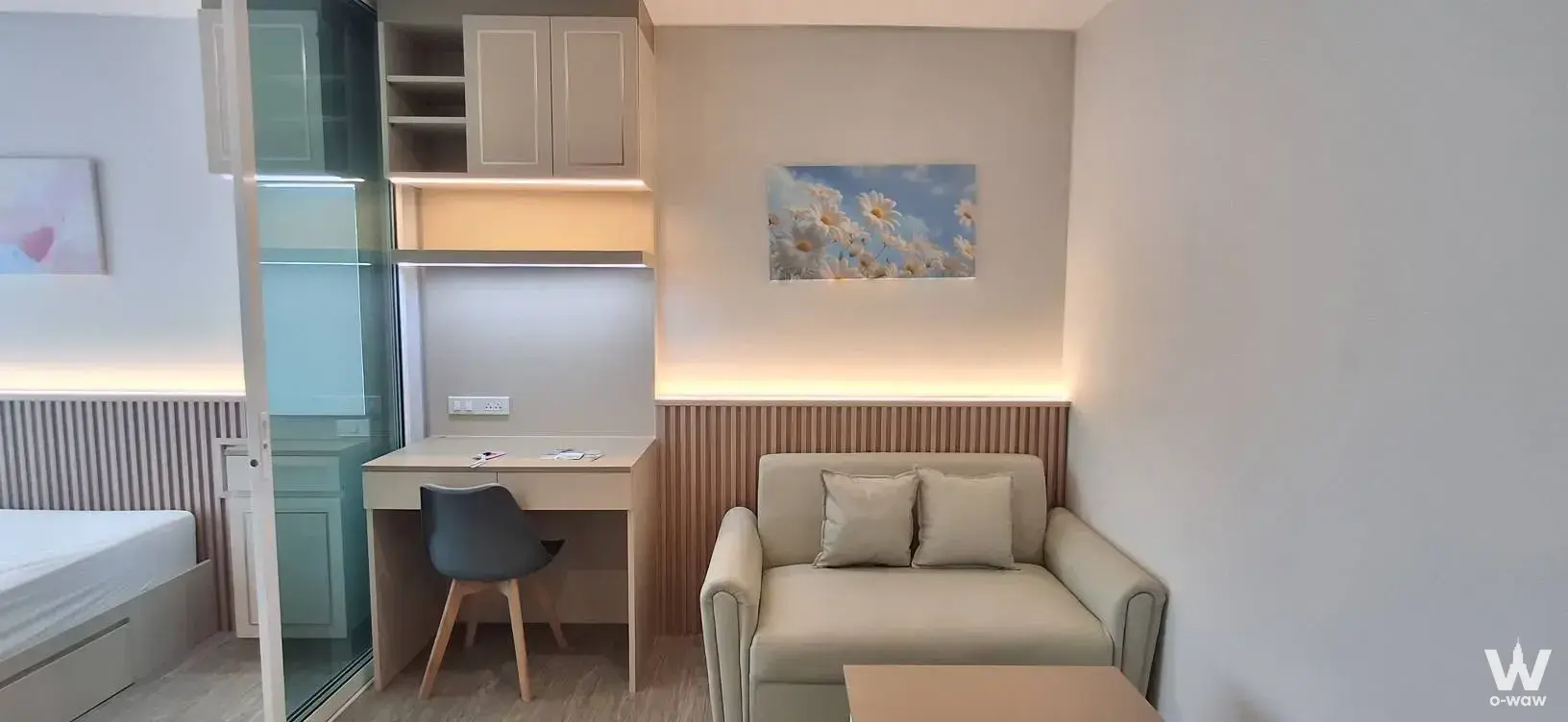 Furnished studio apartment with cream sofa and frosted glass partition in Regent Home Bangna