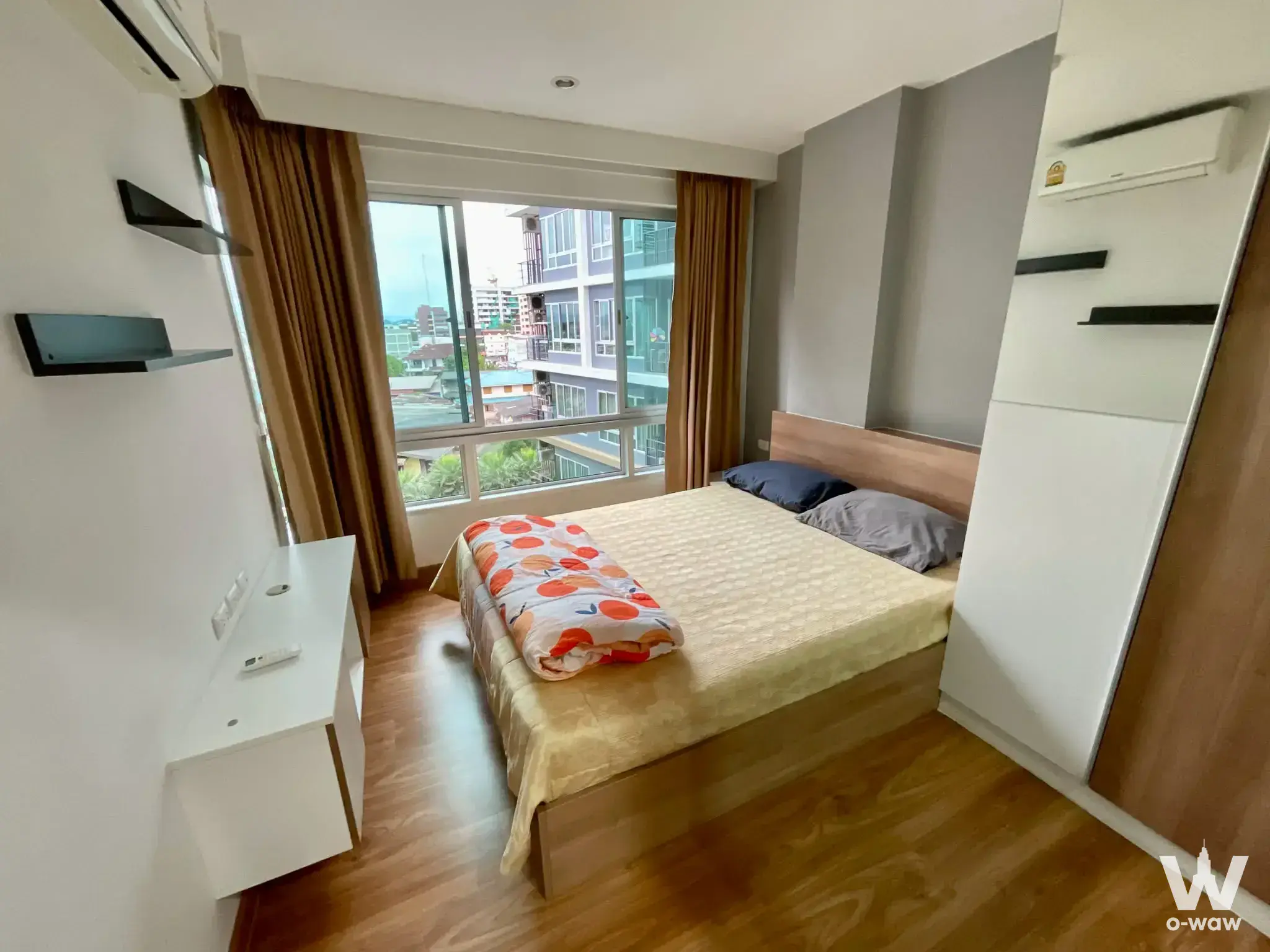 1-bed condo for sale in The Fortynine Plus 2 bedroom with city view, orange patterned blanket, and wood flooring