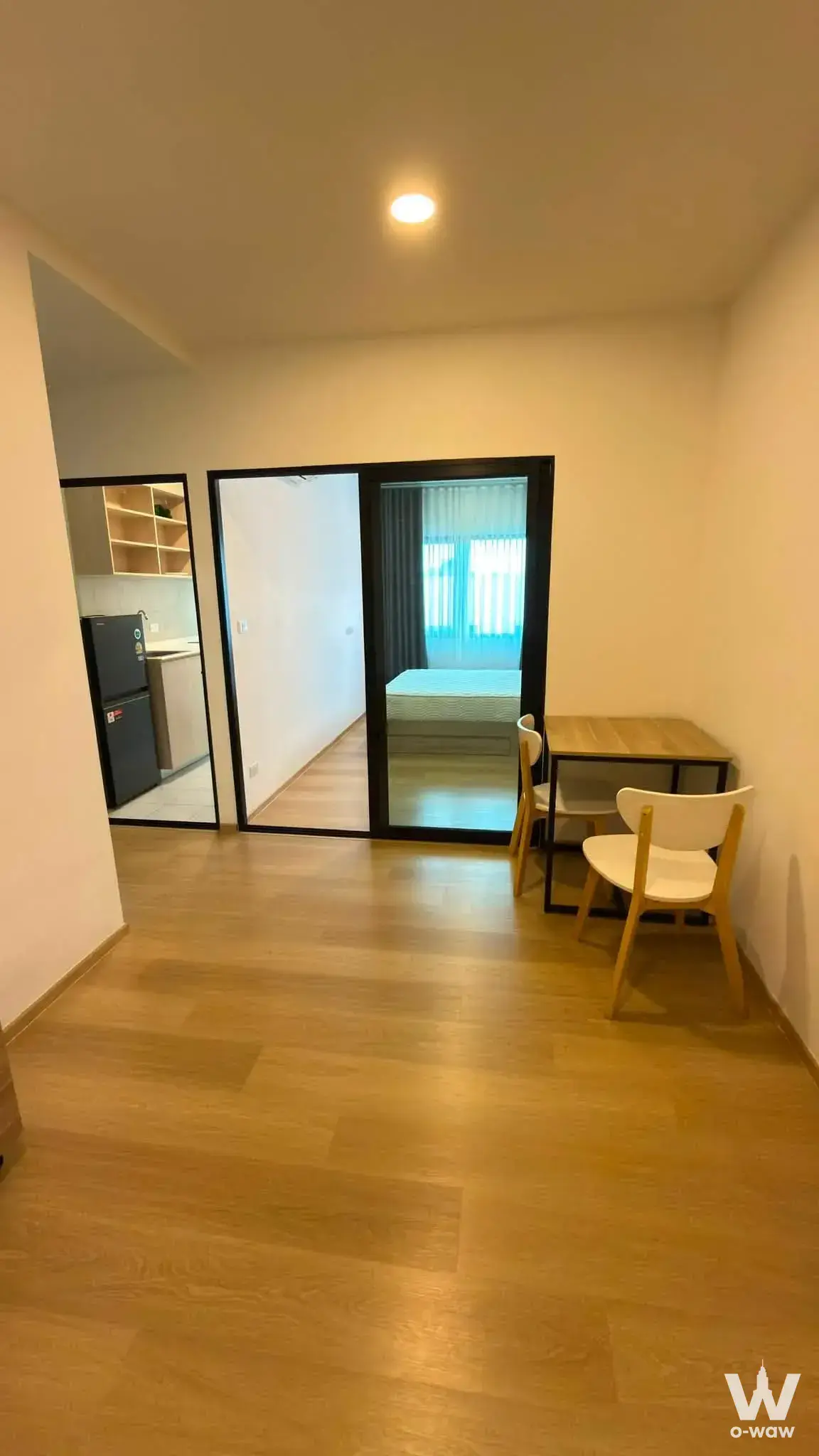 Compact studio with sliding glass partition and dining nook in Chewathai Hallmark Ladprao